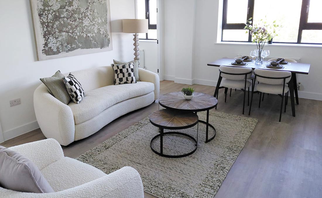 Styled living and dining area with boucle sofas and coordinated furniture package
