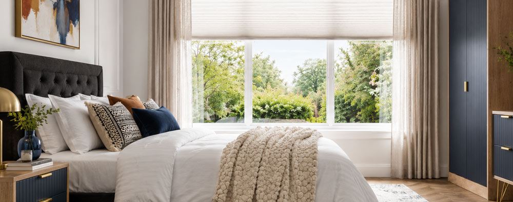 Bedroom with pleated blind, curtains and navy fitted wardrobe
