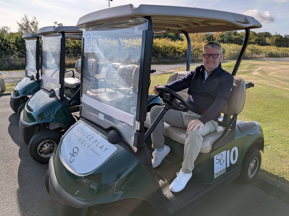 Andrew Biggs at the wheel of a Stroke Play Golf buggy