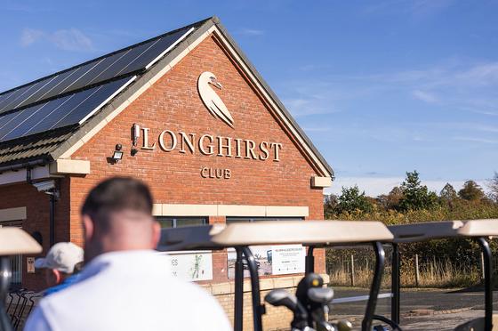 The Longhirst Club clubhouse, with golf buggies in the foreground