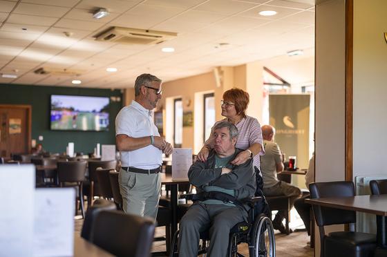 Andrew chatting with a guest and his wife in the clubhouse