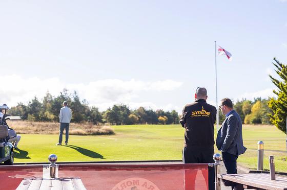 Two guests looking out over the course from the clubhouse terrace